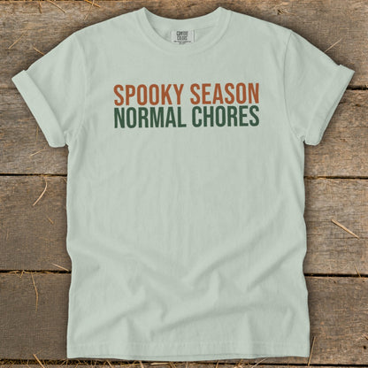 Light green t-shirt with text "SPOOKY SEASON NORMAL CHORES".