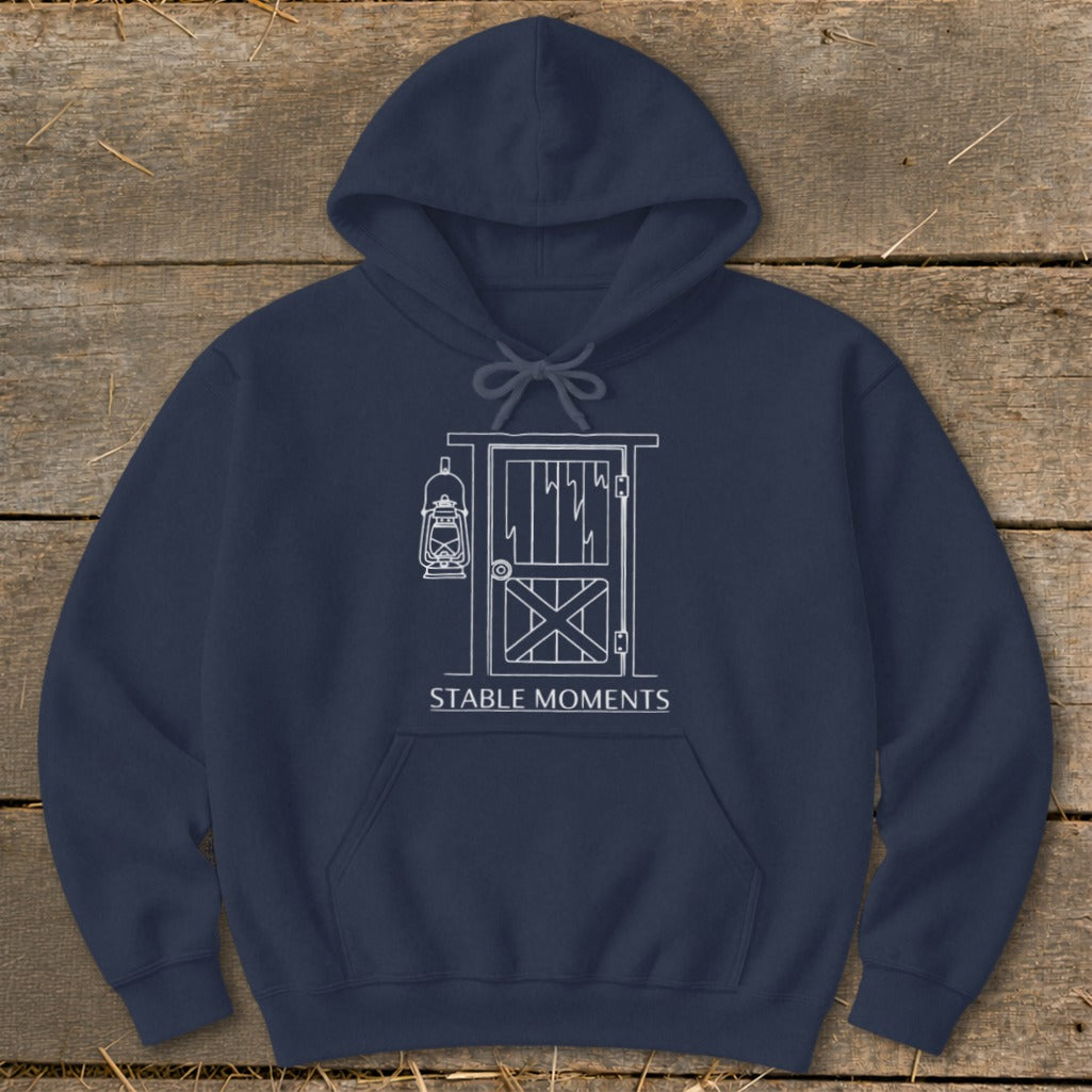 Navy hoodie with white line art of a barn door, lantern, and "Stable Moments" text.