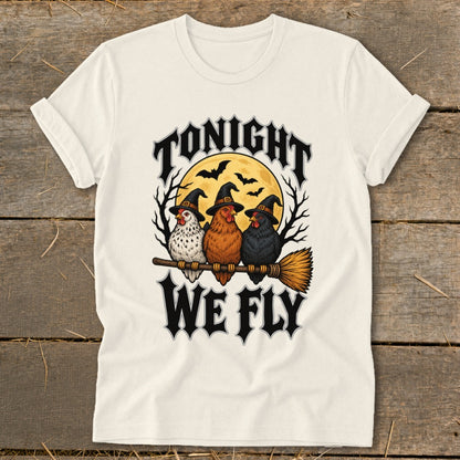 Three chickens in witch hats ride a broomstick under "TONIGHT WE FLY" text.