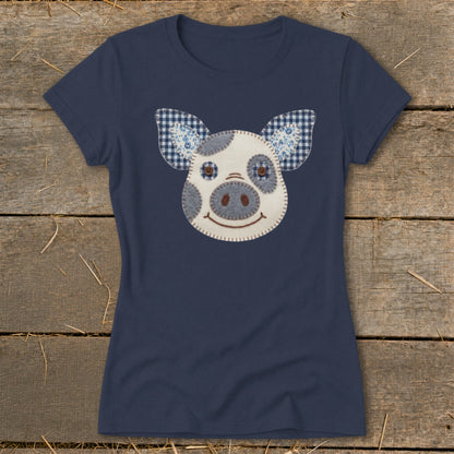 Navy t-shirt with a stuffed pig face applique and checkered blue ears.