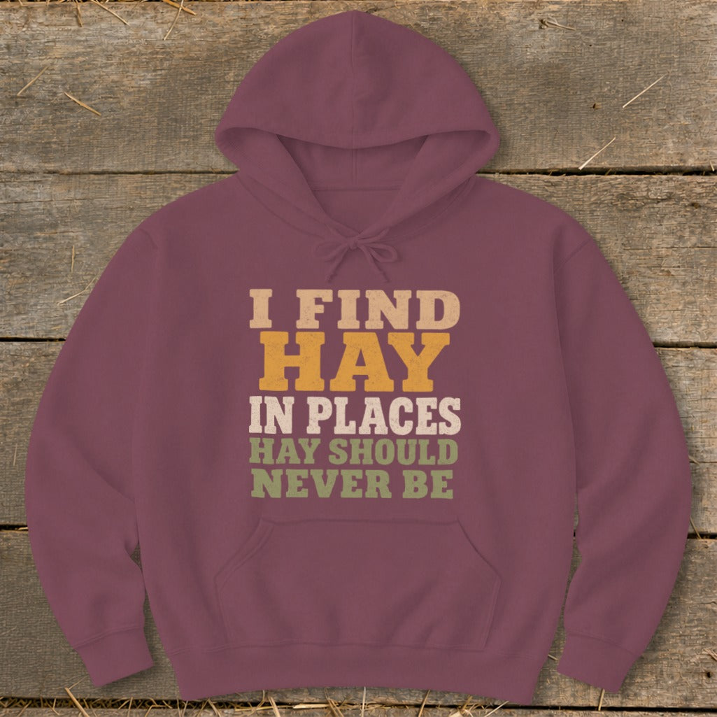 Maroon hoodie with text "I FIND HAY IN PLACES HAY SHOULD NEVER BE".