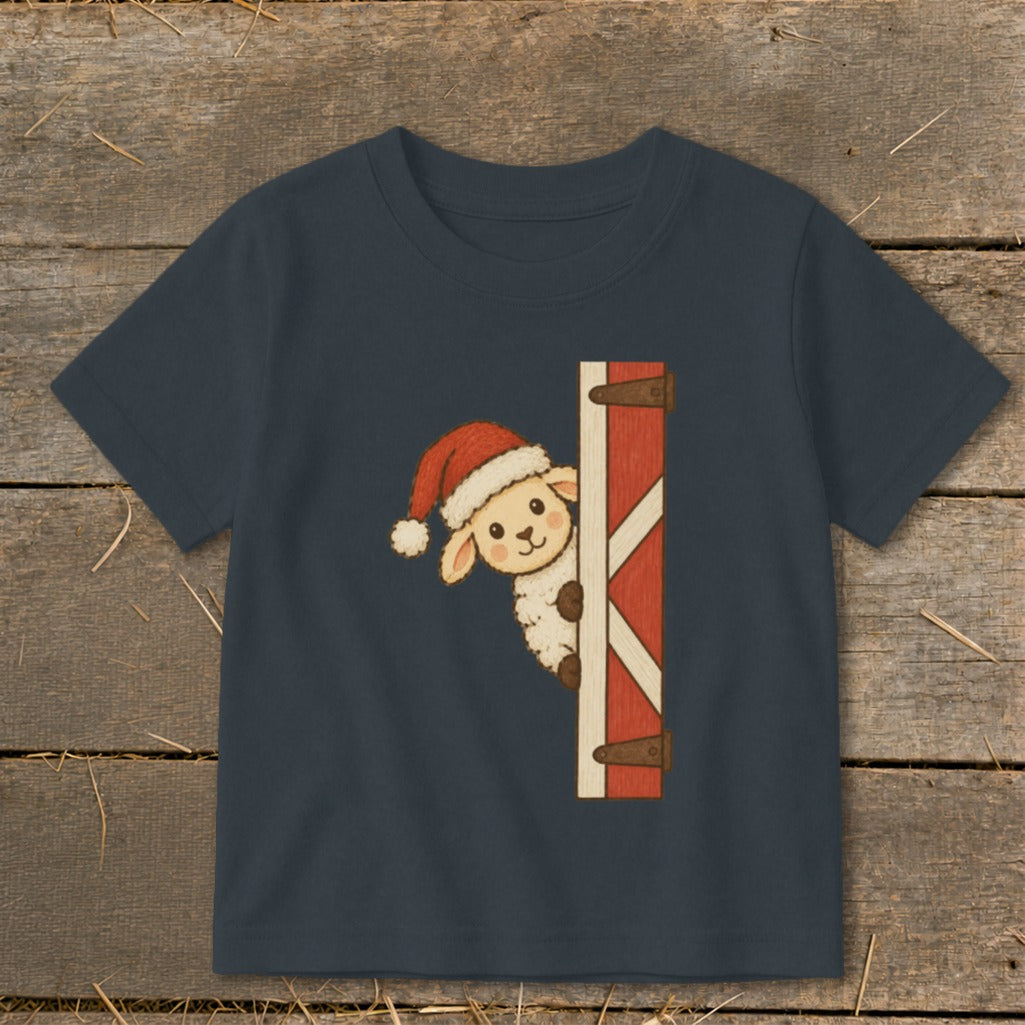 Dark blue t-shirt with a cartoon sheep wearing a Santa hat peeking from behind a barn door.