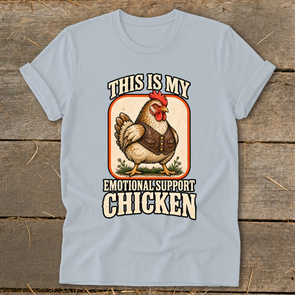 Light blue t-shirt with graphic of a chicken wearing a vest and text "This is my emotional support chicken".