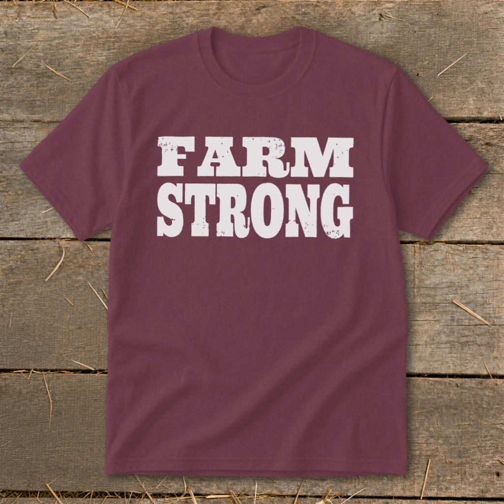 Maroon short-sleeved t-shirt with distressed white text reading "FARM STRONG" displayed centrally.