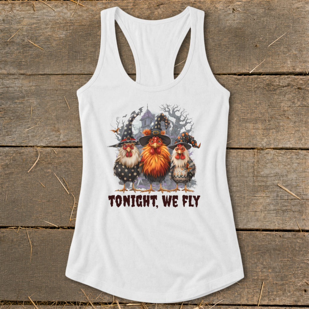 Three chickens wearing witch hats stand before a spooky house. "TONIGHT, WE FLY" text.