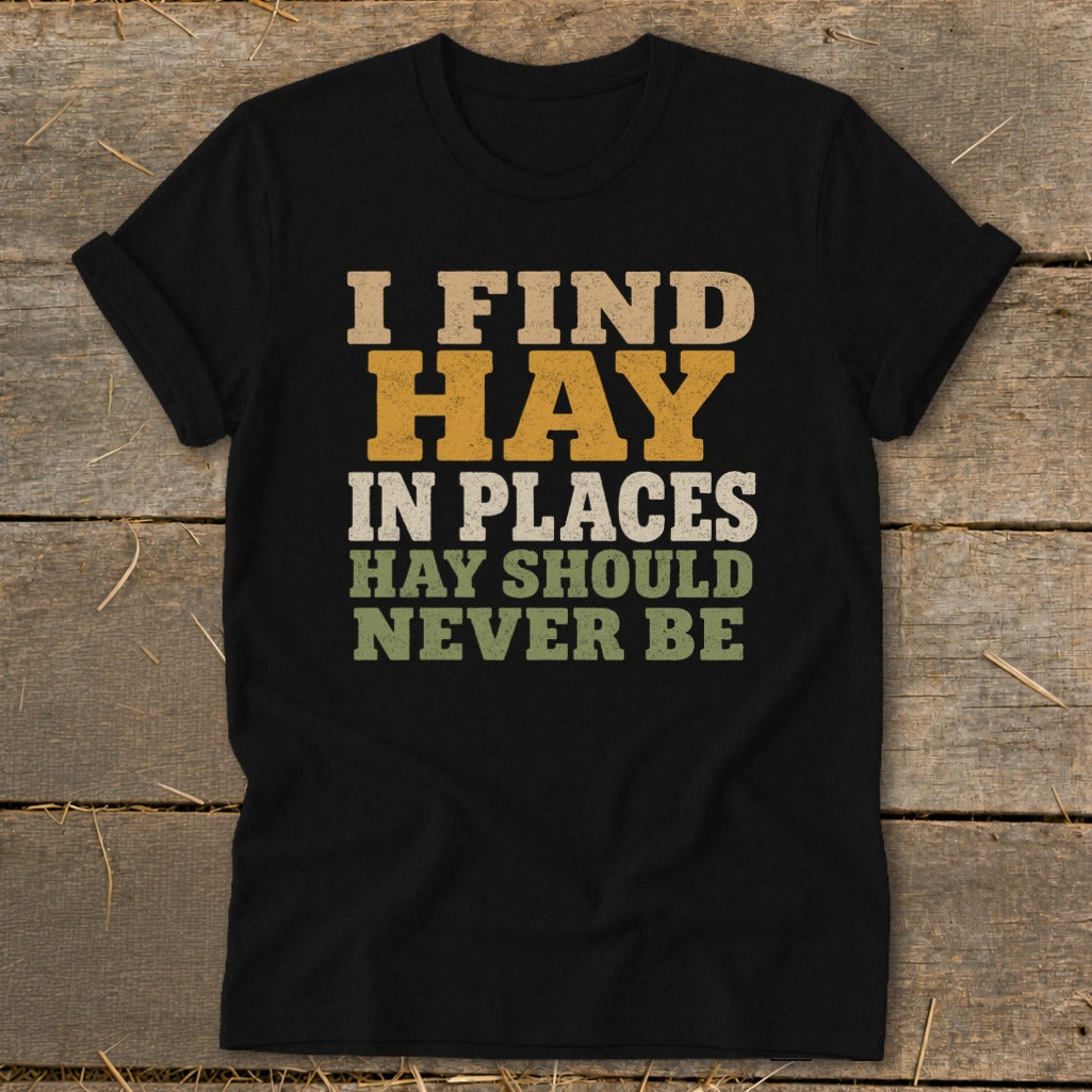 Black t-shirt with text "I FIND HAY IN PLACES HAY SHOULD NEVER BE"