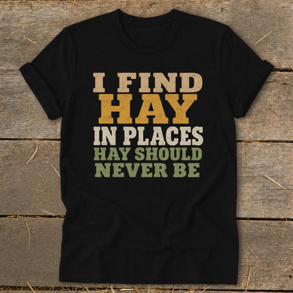 Black t-shirt with text "I FIND HAY IN PLACES HAY SHOULD NEVER BE"