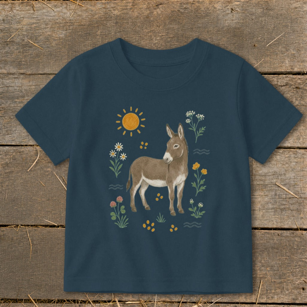 Navy t-shirt with illustration of a donkey surrounded by sun, flowers, and clover.