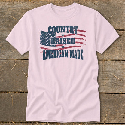 Light pink t-shirt with distressed American flag graphic and text: Country Raised American Made.