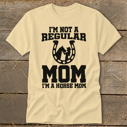 Light yellow t-shirt with "I'M NOT A REGULAR MOM" and horse graphic in horseshoe.