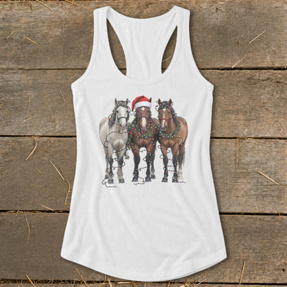 Three horses wearing Christmas lights and garlands on a white tank top.