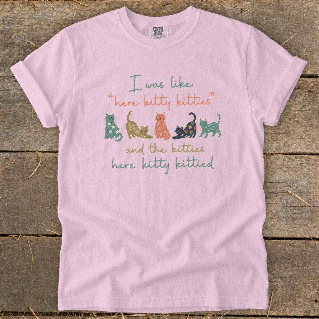 Pink t-shirt with "here kitty kitties and the kitties here kitty kittied" text and colorful cats.