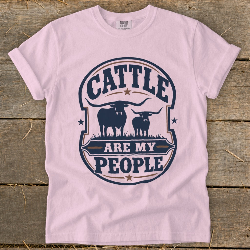 Pink t-shirt with "CATTLE ARE MY PEOPLE" text and two longhorn cattle graphics.