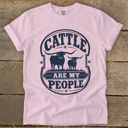 Pink t-shirt with "CATTLE ARE MY PEOPLE" text and two longhorn cattle graphics.