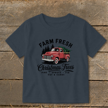 T-shirt with a red truck carrying a Christmas tree and the text "Farm Fresh Christmas Trees".