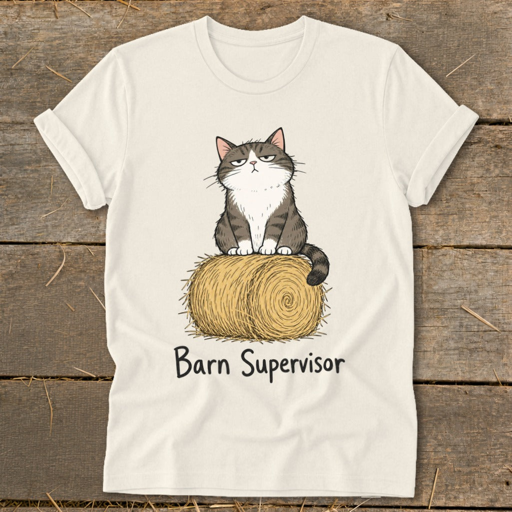 White t-shirt with a grumpy cat sitting on a hay bale, text reads "Barn Supervisor".