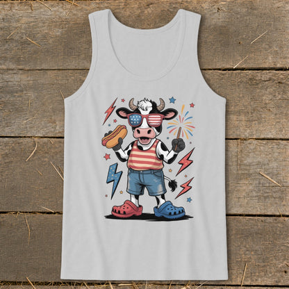 Cartoon cow in patriotic outfit holding hot dog and sparkler with fireworks and lightning bolts.