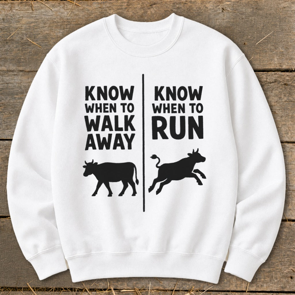 White sweatshirt with black text and cow silhouettes: "Know When to Walk Away" and "Know When to Run".