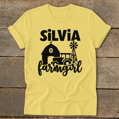 Yellow t-shirt with "Silvia farmgirl" text, barn, tractor, and windmill graphic.