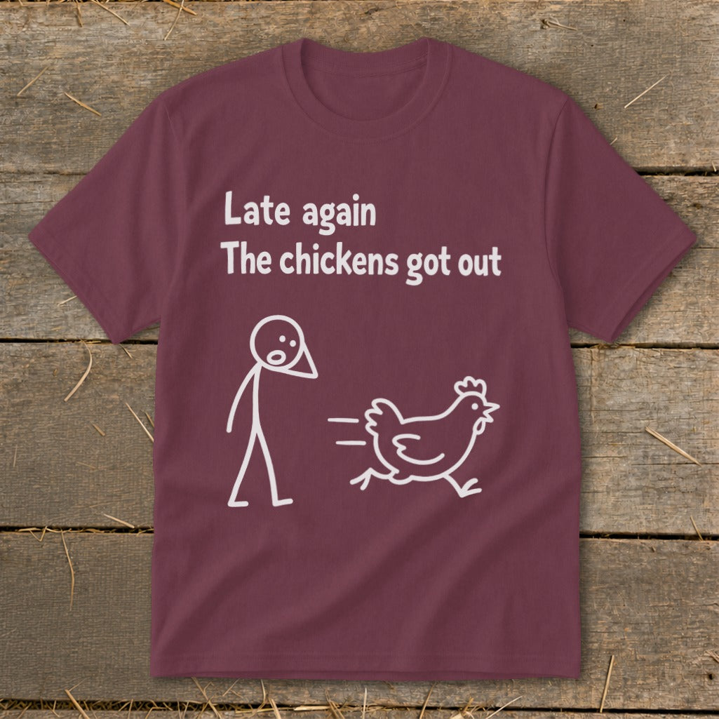 Maroon t-shirt with white text "Late again The chickens got out" and stick figure chasing a chicken.