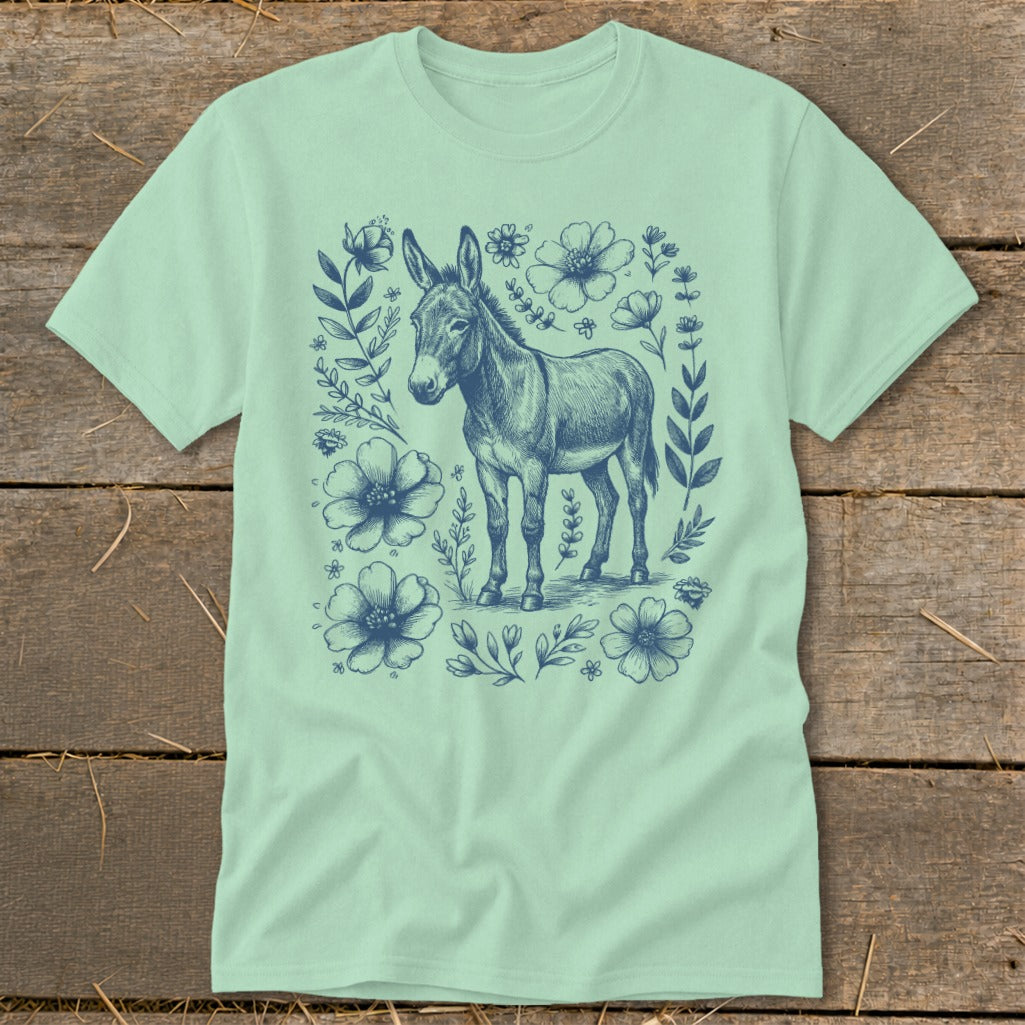 Light green t-shirt with a blue sketch of a donkey surrounded by flowers.