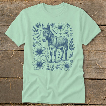 Light green t-shirt with a blue sketch of a donkey surrounded by flowers.