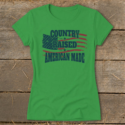 Green t-shirt with "Country Raised American Made" text and distressed American flag graphic.