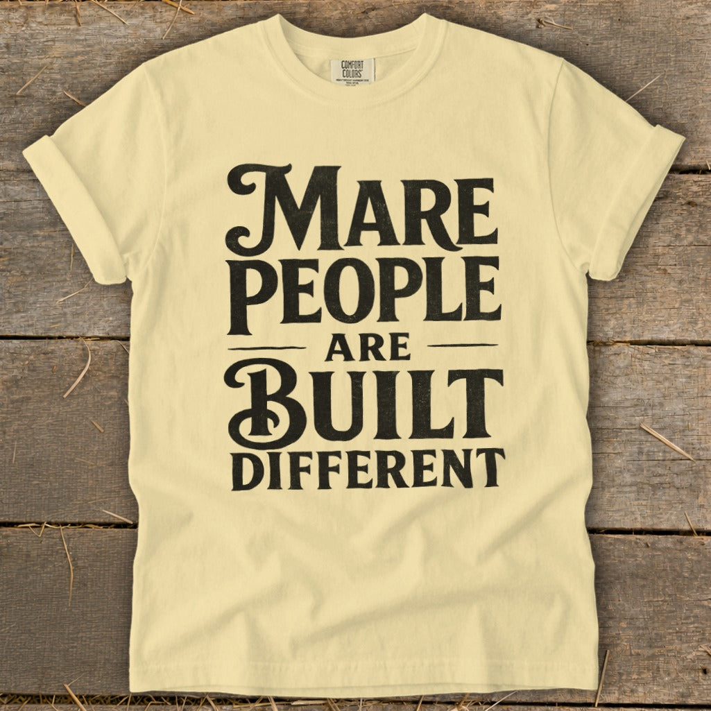 Pale yellow t-shirt with black text that reads "Mare People Are Built Different".