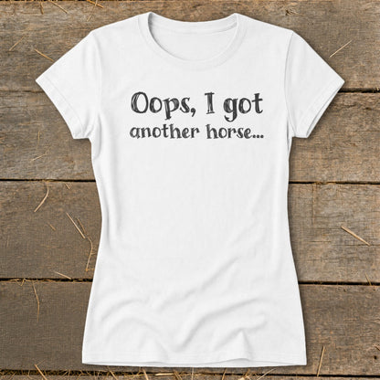White t-shirt with black text reading "Oops, I got another horse..."
