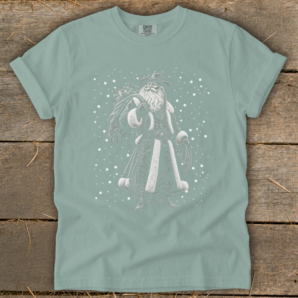 Cowboy Santa graphic on a light blue t-shirt with falling snow.