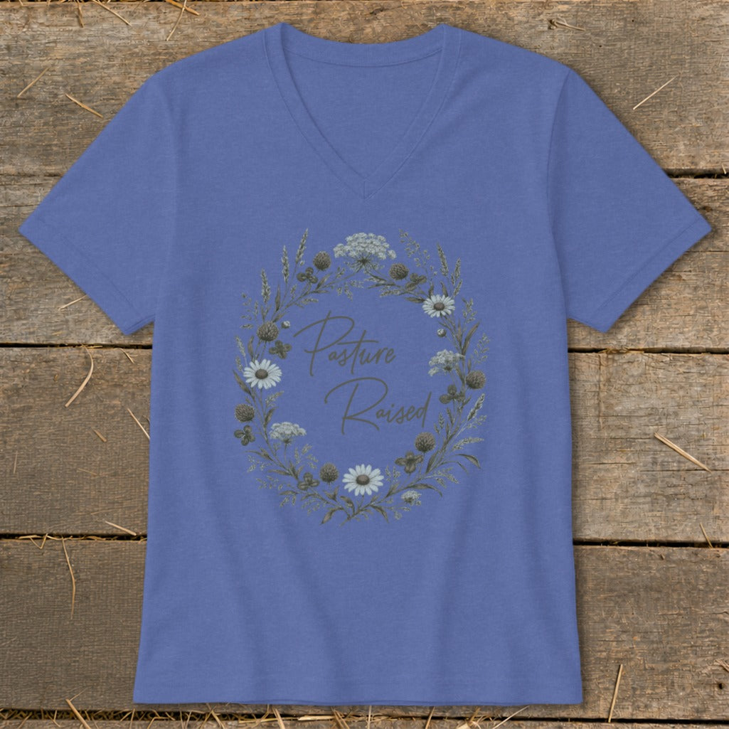Periwinkle v-neck t-shirt with a floral wreath graphic and text "Pasture Raised".
