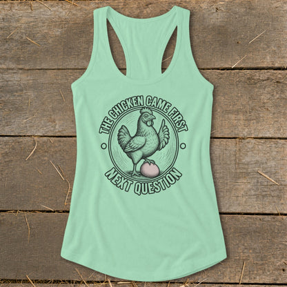 Mint green tank top with a graphic of a chicken and egg and text "The chicken came first next question".