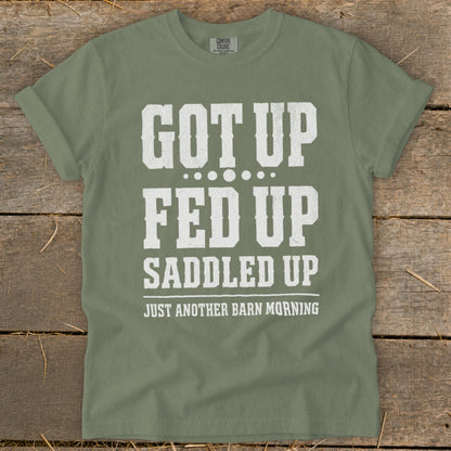 Green t-shirt with white text: "GOT UP FED UP SADDLED UP JUST ANOTHER BARN MORNING"