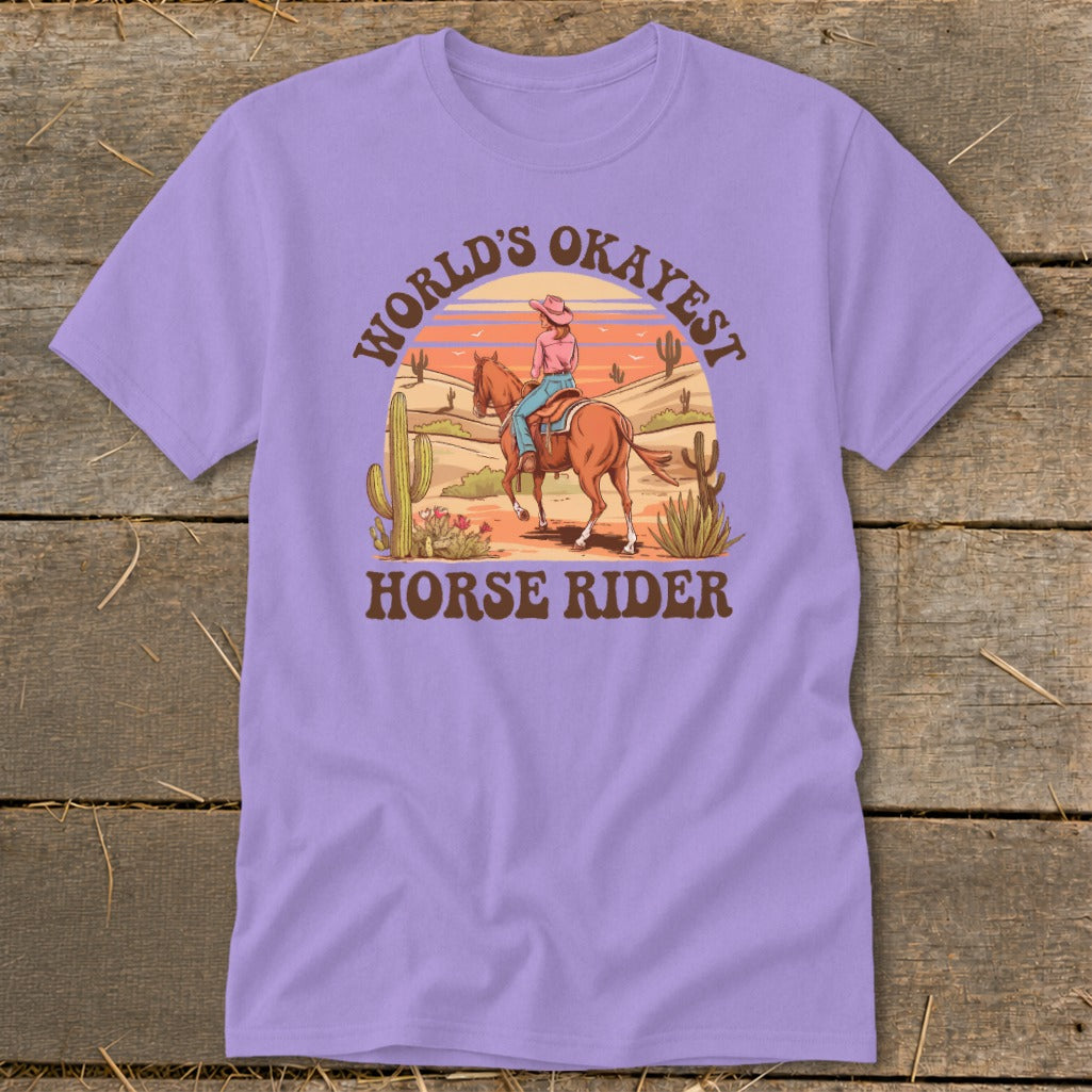 T-shirt with desert scene graphic: "World's Okayest Horse Rider" text.