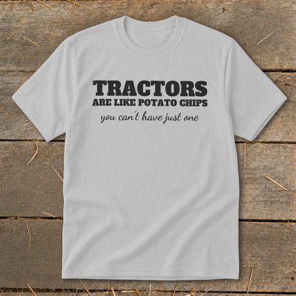 Light grey t-shirt with black text reading "TRACTORS ARE LIKE POTATO CHIPS you can't have just one."