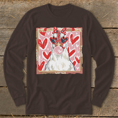 White chicken in heart sunglasses blowing pink bubble gum, red hearts background.