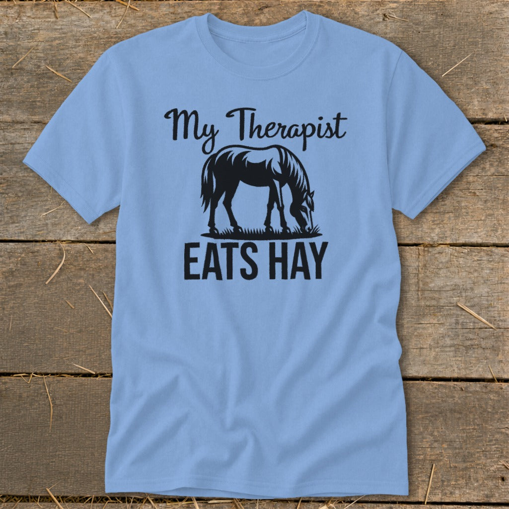 Light blue t-shirt with black text and horse graphic: "My Therapist Eats Hay".