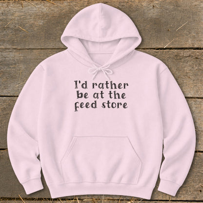 Light pink hoodie with "I'd rather be at the feed store" text.