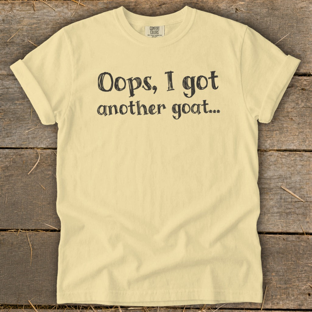 Light yellow t-shirt with black text "Oops, I got another goat...".