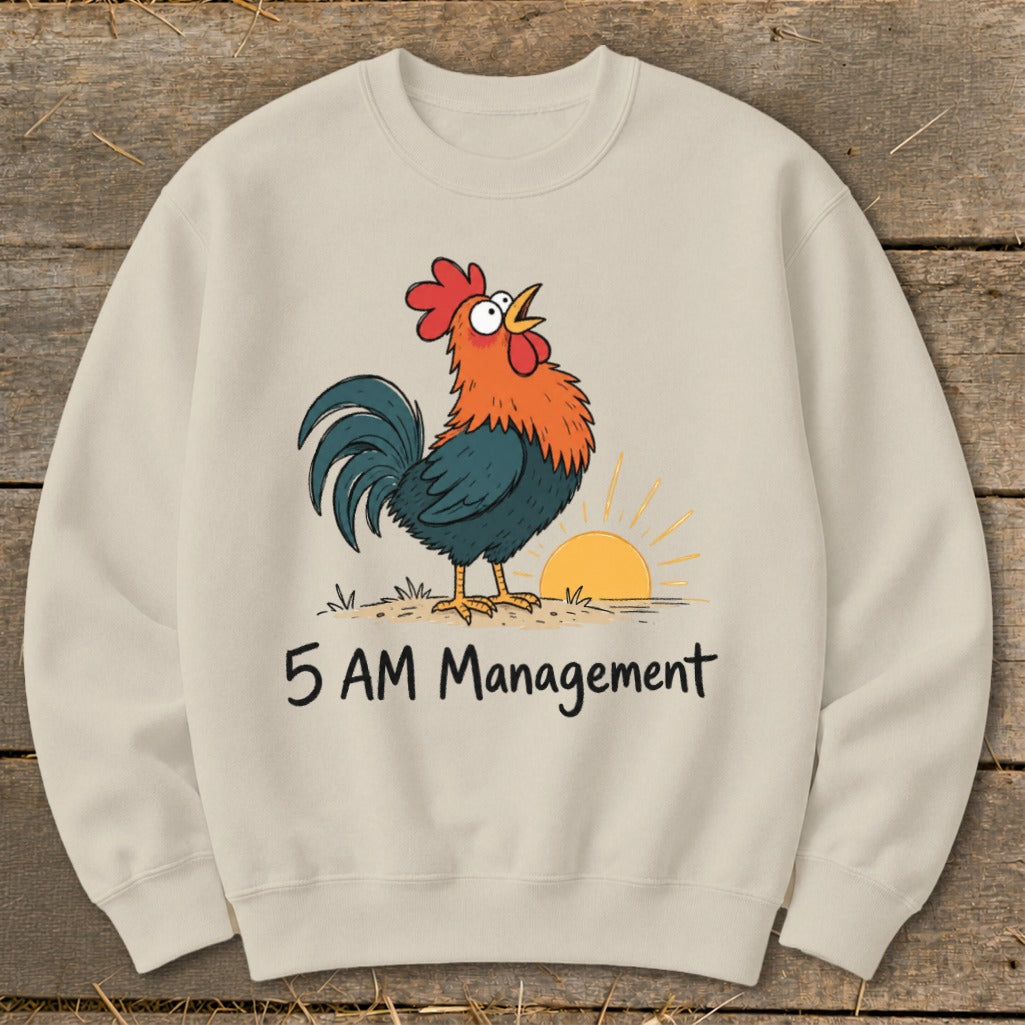 Cream sweatshirt with cartoon rooster, sunrise, and text "5 AM Management".