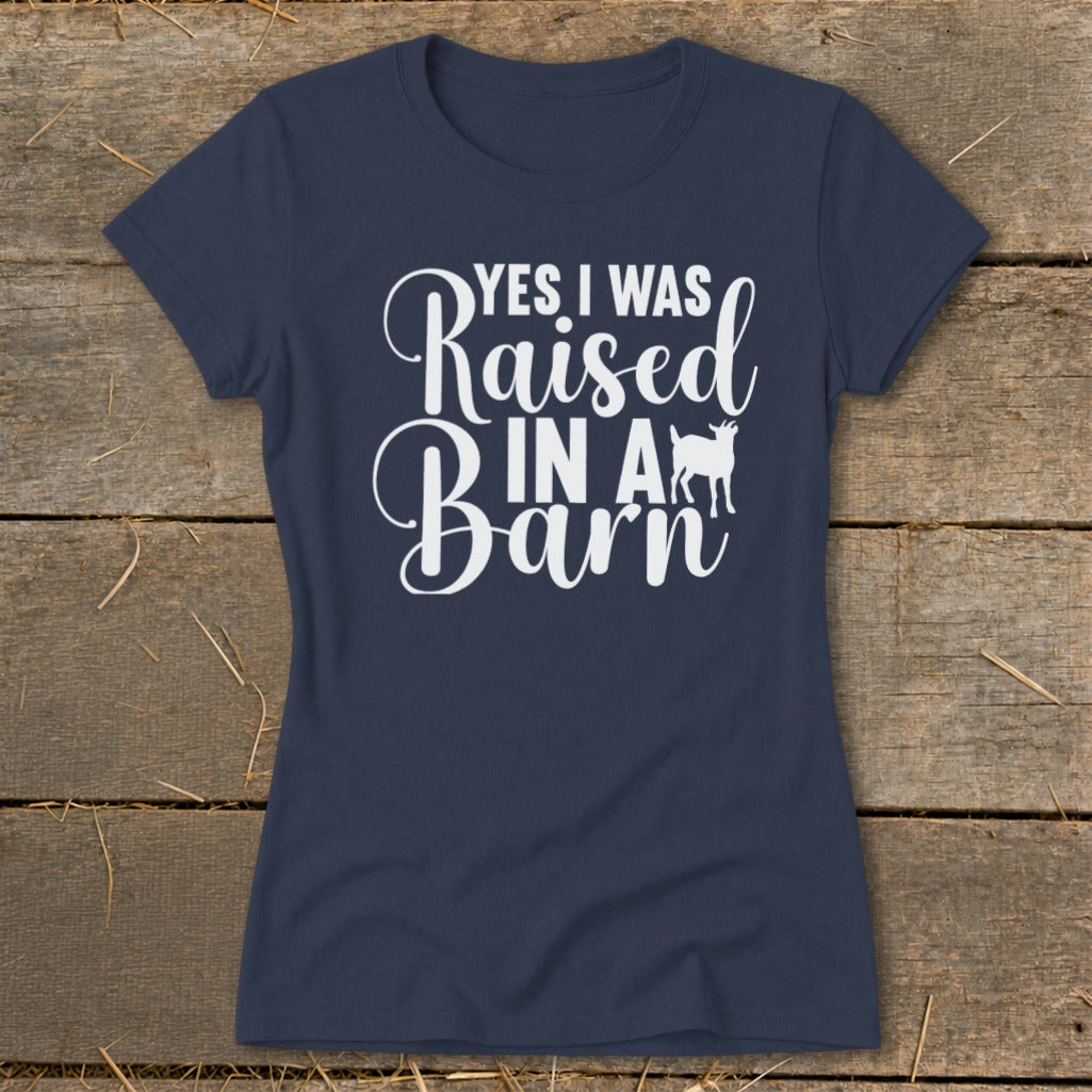 Navy t-shirt with white text that says "YES I WAS Raised IN A Barn" and a goat silhouette.