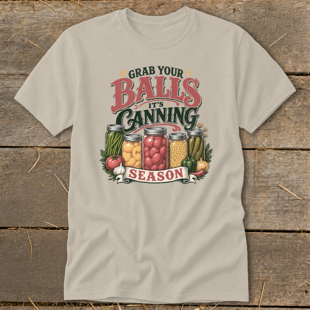 T-shirt graphic with jars of preserved vegetables and "Grab Your Balls It's Canning Season" text.