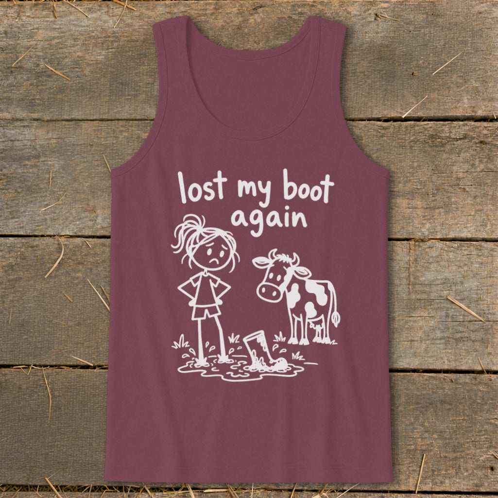 Maroon tank top featuring white graphic text that reads lost my boot again, with a sad girl and a cow standing near a boot in a mud puddle.