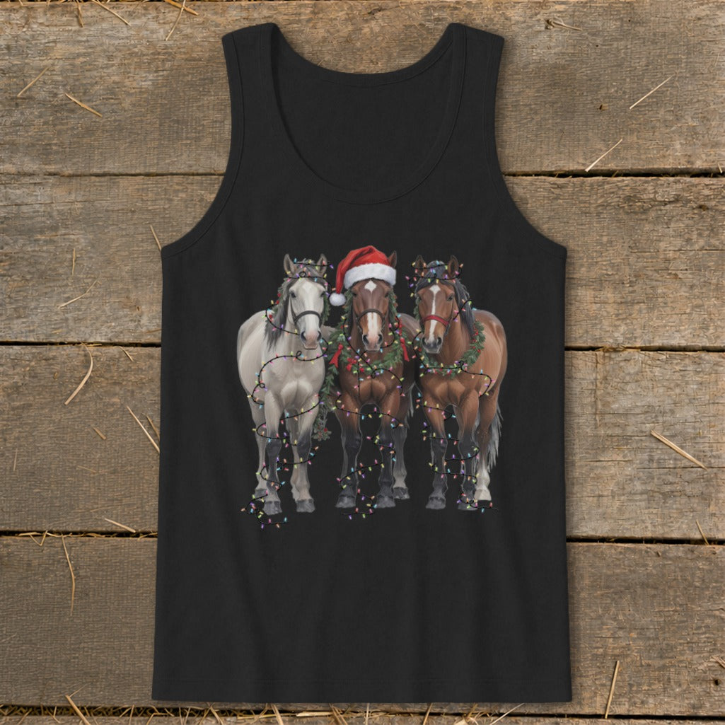 Three horses, one wearing a Santa hat, adorned with Christmas lights and wreaths.