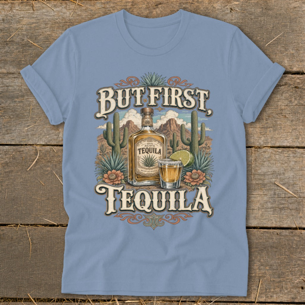 Light blue t-shirt with "But First Tequila" graphic featuring a tequila bottle and shot.