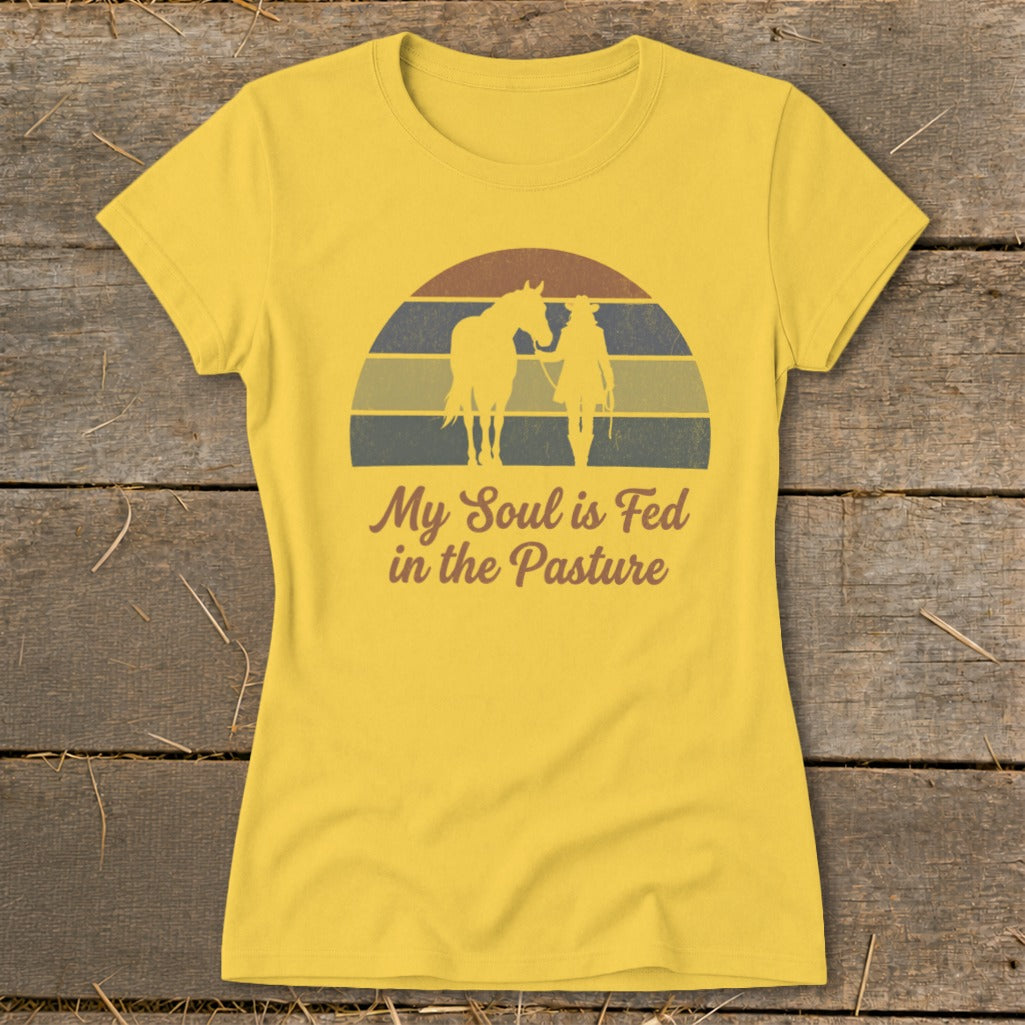 Yellow t-shirt with cowboy and horse silhouette and text "My Soul is Fed in the Pasture".