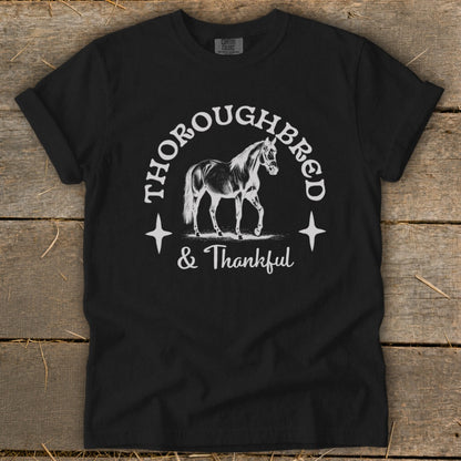 Black t-shirt with "Thoroughbred & Thankful" text and horse graphic.
