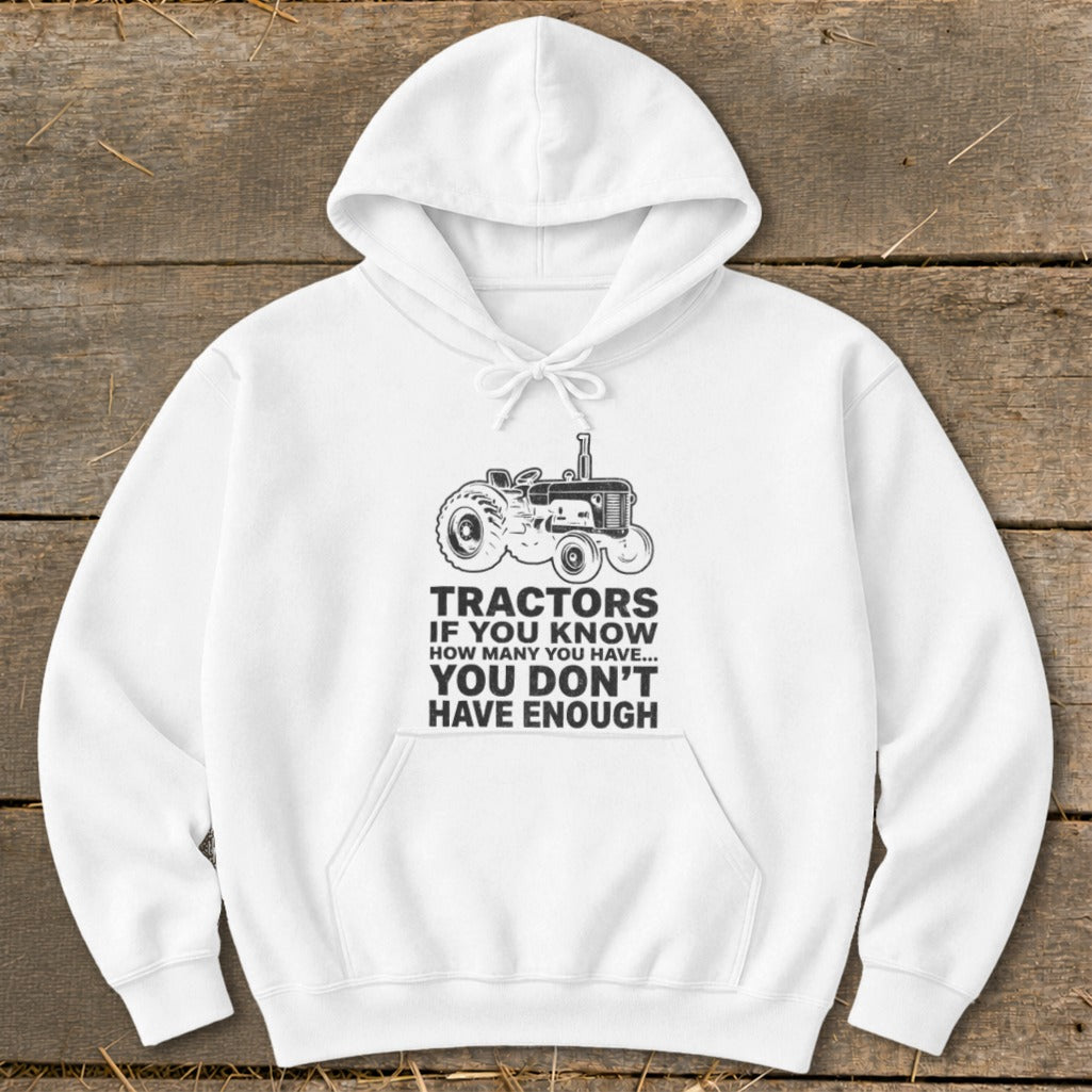 White hoodie with tractor graphic and text: "Tractors if you know how many you have... you don't have enough".