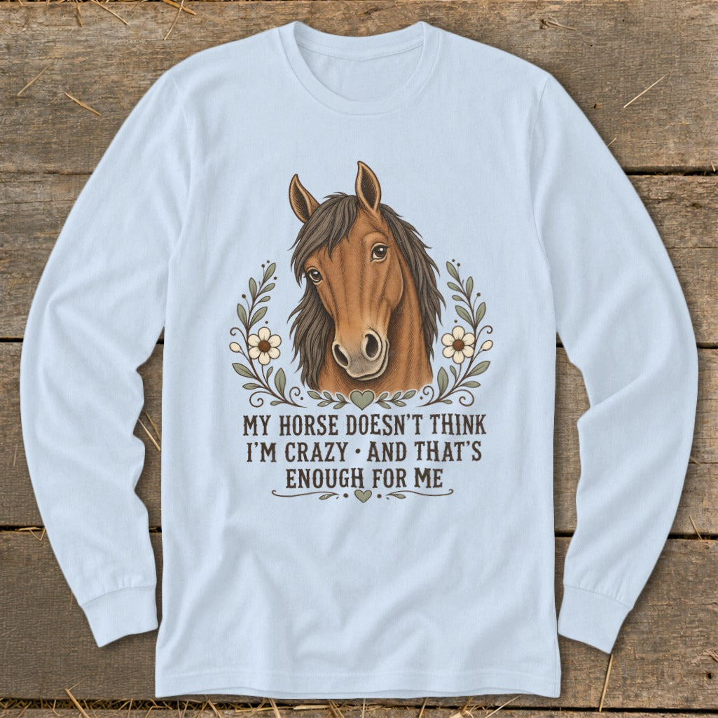 Light blue long-sleeve shirt with horse graphic and text "My horse doesn't think I'm crazy and that's enough for me."