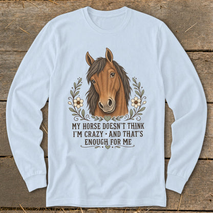 Light blue long-sleeve shirt with horse graphic and text "My horse doesn't think I'm crazy and that's enough for me."